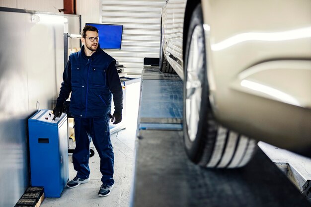 car-mechanic-garage-lifting-car-look-it